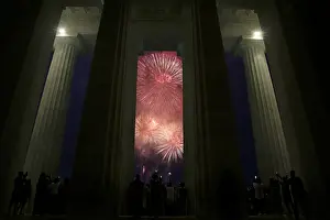 People watch fire works explode at the Lincoln Memorial in celebration of 241st