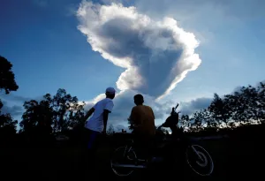 Indonesia Prints: People watch as Mount Merapi volcano erupts from Purwobinangun Village, near Yogyakarta