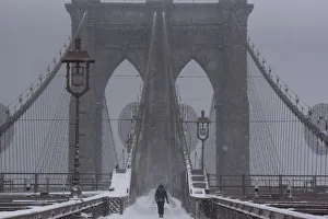 A person walks over the Brooklyn Bridge during winter storm Niko in New York City A person walks over the Brooklyn Bridge during winter storm Niko in New York City