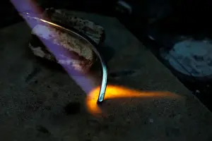 A piece of silver jewellery is seen during preparation in the workshop of goldsmith