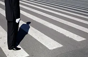 A plainclothes security officer stands guard in front of the Great Hall of the People