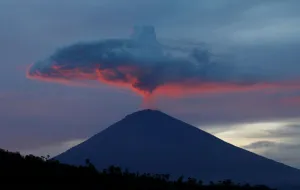 Indonesia Prints: A plume of smoke above Mount Agung volcano is illuminated at sunset as seen from Amed