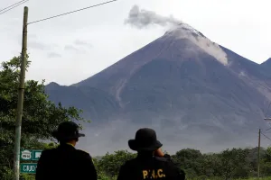 Guatemala Prints: Police officers observe a lahar flowing down from the Fuego volcano at El Rodeo in
