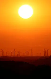 Power-generating windmill turbines are pictured during sunset from the Drachenberg hill