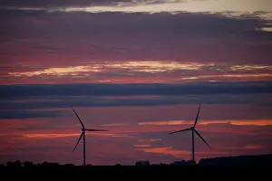 France Prints: Power-generating windmill turbines are pictured during sunset at a wind park in