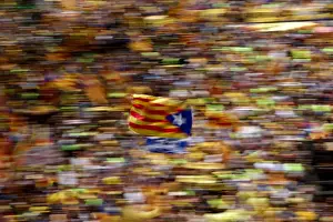 Politic Prints: A pro-independence supporter waves a Catalan separatist flag, known as Estelada