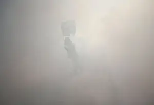Prints of A protester holds a Palestinian flag as he stands amidst tear gas fired by Israeli troops during clashes following a protest against the near-by Jewish settlement of Qadomem Israel Prints: Protester holds a Palestinian flag as he stands amidst tear gas fired by Israeli troops