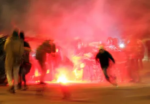 Prints of A protester runs away from the police after lighting a flare in Moscow, December 15, 2010 Russia Prints: A protester runs away from the police after lighting a flare in Moscow