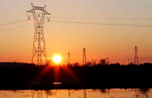 Pylons of high-tension electricity power lines are seen during sunset in Bordeaux