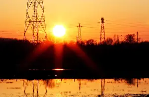 Energy Prints: Pylons of high-tension electricity power lines are seen during sunset in Bordeaux