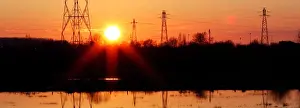 Energy Prints: Pylons of high-tension electricity power lines are seen during sunset in Bordeaux