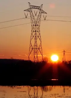 Energy Prints: Pylons of high-tension electricity power lines are seen during sunset in Bordeaux