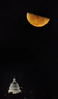 The Third Quarter moon rises over the U. S. Capitol dome shortly after midnight in