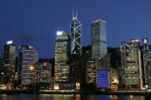 Queens Pier is lit up in front of skyline in Hong Kongs central financial district