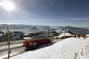 A rack railcar of Rigi Bahn railways leaves the peak of Mount Rigi near Lake Lucerne