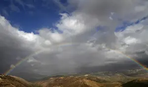 A rainbow stretches over Mount Haramoun as seen from the southern Lebanese village
