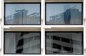 Sri Lanka Prints: Reflection of construction sites is seen on glass panels of a building in Colombo