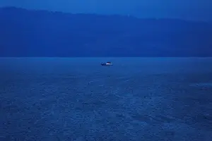 A rescue boat is seen at a location of a ferry that sank earlier this week in Lake Toba
