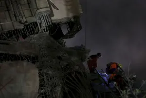 Images Dated 2016 February: Rescue personnel search the debris of a 17-storey apartment building that collapsed after