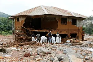 Rescue workers are seen searching through rubbles around a house for bodies at Pentagon