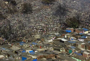 India Prints: Residents attempt to salvage belongings from gutted hutments in a slum area in Mumbai
