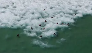 Residents and tourists enjoy the sea at Barra da Tijuca beach during a summer day