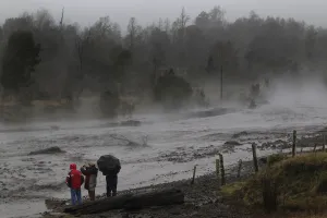 Volcano Prints: Residents watch as steam rises from the Nilhue River, fed by unusually warm water