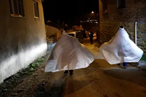 Turkey Prints: Revellers wrapped in white sheets walk during the aeBocuk nightA