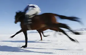 Riders compete on frozen Yenisei River during 47th Ice Derby amateur horse race near