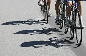 Riders shadows are projected on the road during the fourth stage of the Tour de Suisse