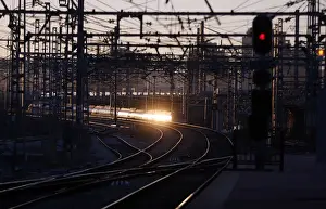 The rising sun reflects on a departing train during a 24-hour nationwide train strike