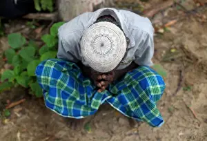 A Rohingya refugee waits to receive permission from the Bangladeshi army to continue