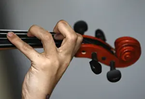 A Roma child plays the violin during a lesson organised by the Hungarian Talentum