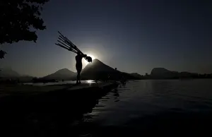 Trending: A rowing athlete carries paddles ahead of training session at the World Rowing Junior