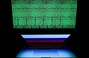 Cyber Prints: Russian flag is seen on the laptop screen in front of a computer screen on which cyber