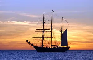 Sail training barquentine ship Leeuwin sails in the Indian Ocean at sunset off