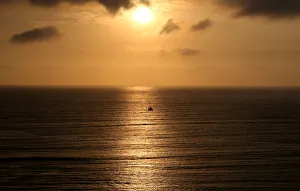 Latin America Prints: A sailboat sails during sunset in the Pacific Ocean in Lima