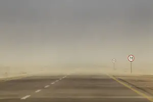 Sand blows across the coastal highway near Brega in eastern Libya