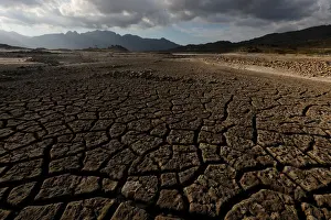 Safrica Prints: Sand blows across a normally submerged area at Theewaterskloof dam near Cape Town