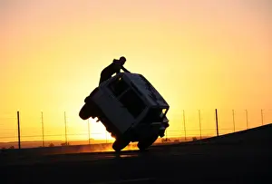 Saudi men perform a stunt known as sidewall skiing in Tabuk