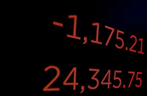 Stock Prints: A screen displays the Dow Jones Industrial Average following the closing bell on