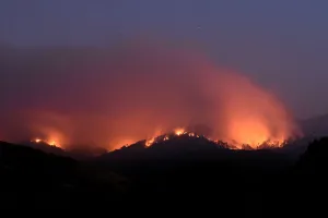 California Prints: Seen in a long exposure photograph, the Soberanes Fire burns along ridges above