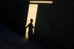 Shadow of an Afghan boy, standing by the door of a mosque, is cast on a wall in the Shadow of an Afghan boy, standing by the door of a mosque, is cast on a wall in the