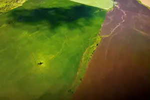 The shadow of a plane is seen in a field shortly after take-off from Samara Airport