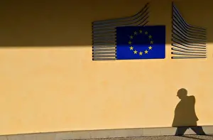 The shadow of a worker is seen beside the EU Commission building in Brussels, Belgium