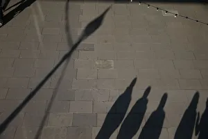 Prints of The shadows of pedestrians are cast on the pavement as they walk along the South Bank in the afternoon sun, in central London, Britain February 24, 2018. REUTERS/Paul Hackett Britain Prints: The shadows of pedestrians are cast on the pavement as they walk along the South Bank in