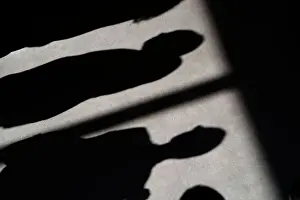 Shadow Prints: Shadows of people are cast on the carpet of the United Nations Security Council before