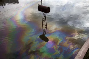 Sandy Prints: A sheen caused by spilled fuel shines on water left in a street by the storm surge of