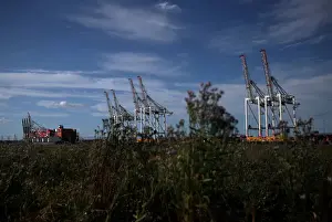Eu Prints: Shipping containers stacked on a cargo ship are seen in the dock at the ABP port in