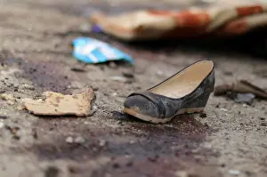 A shoe is seen near blood stains following a car bomb attack in Hasaka province